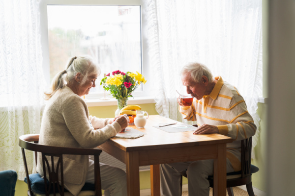 Happy couple walking arm in arm at an assisted living community
