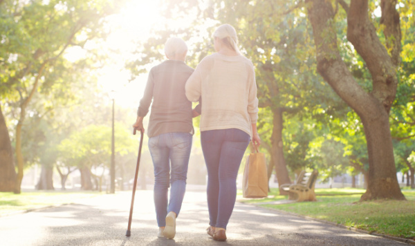 Older adult walking safely with family support as part of fall prevention and independent living planning