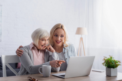 Adult daughter reviewing Medicare and senior care information with her aging mother.